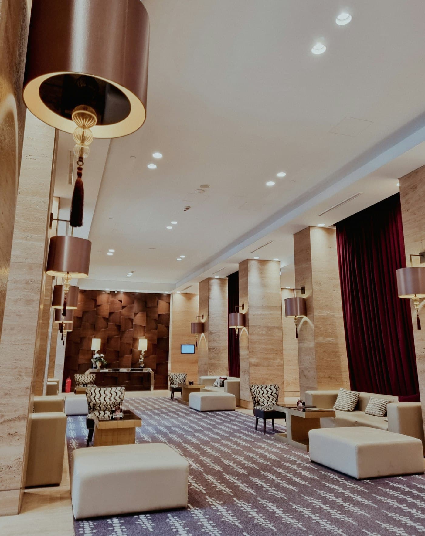 Travertine hotel lounge with brass lamps